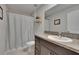 Bathroom featuring a dark vanity with granite look countertop and a framed mirror at 13506 Wild Ginger St, Riverview, FL 33579