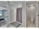 Well-lit bathroom featuring a shower with a curtain, a toilet, and neutral color scheme at 13506 Wild Ginger St, Riverview, FL 33579