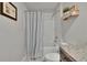 Bathroom with shower and tub combination, granite countertop, wood cabinets, and tiled floors at 13506 Wild Ginger St, Riverview, FL 33579