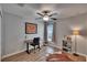 Bedroom features a ceiling fan, a work desk, and wood-look flooring at 13506 Wild Ginger St, Riverview, FL 33579