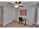 Office setup with a ceiling fan, closet, and desk illuminated by natural light from a window at 13506 Wild Ginger St, Riverview, FL 33579