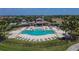 Aerial view of a community pool and clubhouse with lounge chairs at 13506 Wild Ginger St, Riverview, FL 33579
