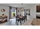 Dining area featuring an elegant chandelier and sliding glass doors providing outdoor views at 13506 Wild Ginger St, Riverview, FL 33579