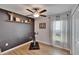 Exercise room has wood-look floors, decorative shelf, a bike, and white curtains at 13506 Wild Ginger St, Riverview, FL 33579