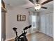 Exercise room with white closet doors and a mounted bike plus ceiling fan at 13506 Wild Ginger St, Riverview, FL 33579