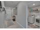 Inviting hallway leading to a laundry room with modern washer and dryer at 13506 Wild Ginger St, Riverview, FL 33579