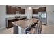 Modern kitchen with stainless appliances, dark wood cabinets, granite countertops, and a large island at 13506 Wild Ginger St, Riverview, FL 33579