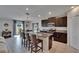 Spacious kitchen featuring a granite island with barstool seating, stainless appliances, and a view to the dining area at 13506 Wild Ginger St, Riverview, FL 33579
