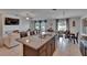 Granite kitchen island with seating overlooks the living and dining areas creating an inclusive space at 13506 Wild Ginger St, Riverview, FL 33579
