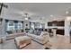Open-concept living room with sofas, adjacent dining area, and kitchen with bar seating at 13506 Wild Ginger St, Riverview, FL 33579
