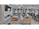 Bright living room with large sofas, ceiling fan, and view to backyard through sliding glass doors at 13506 Wild Ginger St, Riverview, FL 33579