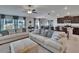 Comfortable living space with couches, a ceiling fan, an adjacent dining area, and a kitchen at 13506 Wild Ginger St, Riverview, FL 33579