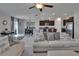 Bright living space with couches, a dining area with a chandelier, and an adjacent kitchen at 13506 Wild Ginger St, Riverview, FL 33579