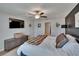 Bedroom featuring a dark accent wall, ceiling fan, modern decor, and natural light at 13506 Wild Ginger St, Riverview, FL 33579