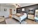 Modern main bedroom featuring a dark accent wall, plush bedding, and stylish decor at 13506 Wild Ginger St, Riverview, FL 33579
