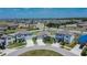 Wide aerial view of the property situated in a residential area with manicured lawns and community landscaping at 13506 Wild Ginger St, Riverview, FL 33579