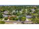 An aerial view displays various homes nestled among mature trees and green spaces in a residential neighborhood at 13891 Feather Sound Dr, Clearwater, FL 33762