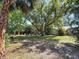 Expansive backyard with mature trees offering ample shade and privacy to enjoy time outdoors at 13891 Feather Sound Dr, Clearwater, FL 33762