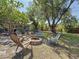 Relaxing backyard with a cozy fire pit, comfortable chairs and a delightful outdoor area to enjoy at 13891 Feather Sound Dr, Clearwater, FL 33762