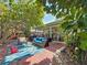 Expansive backyard with a patio, mature trees, and lush landscaping perfect for outdoor enjoyment at 13891 Feather Sound Dr, Clearwater, FL 33762