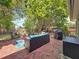 Charming brick patio featuring a cozy seating area, grill, and lush greenery at 13891 Feather Sound Dr, Clearwater, FL 33762