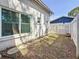 Side yard view with a white fence and stone pathway leading to a private outdoor space at 13891 Feather Sound Dr, Clearwater, FL 33762