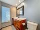Bathroom featuring a wood vanity, large mirror, toilet, neutral wall color, and tile floor at 13891 Feather Sound Dr, Clearwater, FL 33762