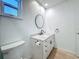 Modern bathroom featuring a white vanity with granite countertop and tiled floor at 13891 Feather Sound Dr, Clearwater, FL 33762