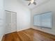 Bright bedroom featuring bamboo floors, a ceiling fan, a window, and a closet at 13891 Feather Sound Dr, Clearwater, FL 33762