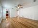 Bedroom with wood floors and a view to an adjoining bathroom at 13891 Feather Sound Dr, Clearwater, FL 33762