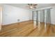 Bedroom with hardwood floors, ceiling fan, and access to the patio via sliding doors at 13891 Feather Sound Dr, Clearwater, FL 33762