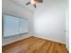 Bright bedroom featuring bamboo floors, a ceiling fan, a large window, and a closet at 13891 Feather Sound Dr, Clearwater, FL 33762