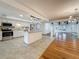 Open concept kitchen featuring granite counters, a center island, and stainless steel appliances at 13891 Feather Sound Dr, Clearwater, FL 33762