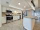 Bright kitchen with stainless steel appliances, granite countertops, and a center island at 13891 Feather Sound Dr, Clearwater, FL 33762