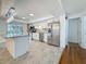 Modern kitchen with stainless steel appliances, granite counters, and bright, stylish pendant lighting at 13891 Feather Sound Dr, Clearwater, FL 33762