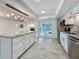 Well-lit kitchen has stainless steel appliances, granite counters, and easy access to the outdoor space at 13891 Feather Sound Dr, Clearwater, FL 33762