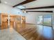 Spacious living room featuring hardwood floors, a vaulted ceiling with wooden beams and ample natural light at 13891 Feather Sound Dr, Clearwater, FL 33762