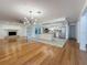 Open-concept living area flows into the kitchen with stainless steel appliances and white cabinetry at 13891 Feather Sound Dr, Clearwater, FL 33762