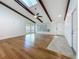 Bright living room boasts hardwood floors, vaulted ceiling with wooden beams, and sliding doors to the backyard at 13891 Feather Sound Dr, Clearwater, FL 33762