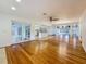 Expansive living room with hardwood floors, patio access, and views into the kitchen at 13891 Feather Sound Dr, Clearwater, FL 33762