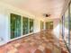 Spacious sunroom featuring large sliding doors and tile flooring at 13891 Feather Sound Dr, Clearwater, FL 33762