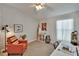 Cozy bedroom featuring a ceiling fan, stylish decor, and a comfortable workspace with natural light at 1406 Bloomingdale Trails Blvd, Brandon, FL 33511