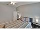 Bedroom showcasing a comfy bed with a 'G' pillow, side tables with lamps, and a ceiling fan at 1406 Bloomingdale Trails Blvd, Brandon, FL 33511