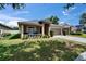 Charming single-story home with a well-manicured lawn, inviting front porch, and two-car garage at 1406 Bloomingdale Trails Blvd, Brandon, FL 33511