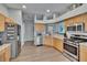 Bright kitchen features stainless appliances, light wood cabinetry, and granite countertops at 1406 Bloomingdale Trails Blvd, Brandon, FL 33511