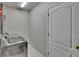 Laundry room with a modern washing machine and door to utility space at 1406 Bloomingdale Trails Blvd, Brandon, FL 33511