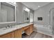 Luxury bathroom features dual sinks, granite counters, and a soaking tub at 1406 Bloomingdale Trails Blvd, Brandon, FL 33511