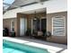 Covered patio seating area near a sparkling backyard pool with a ceiling fan and lots of sunlight at 1406 Bloomingdale Trails Blvd, Brandon, FL 33511