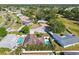 Aerial view of neighborhood featuring lush treelines, homes, and multiple in-ground pools at 14078 Leeward Dr, Seminole, FL 33776