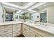 Bathroom features a double sink vanity, quartz countertop and a large mirror at 14078 Leeward Dr, Seminole, FL 33776